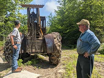 family of loggers working with tractor