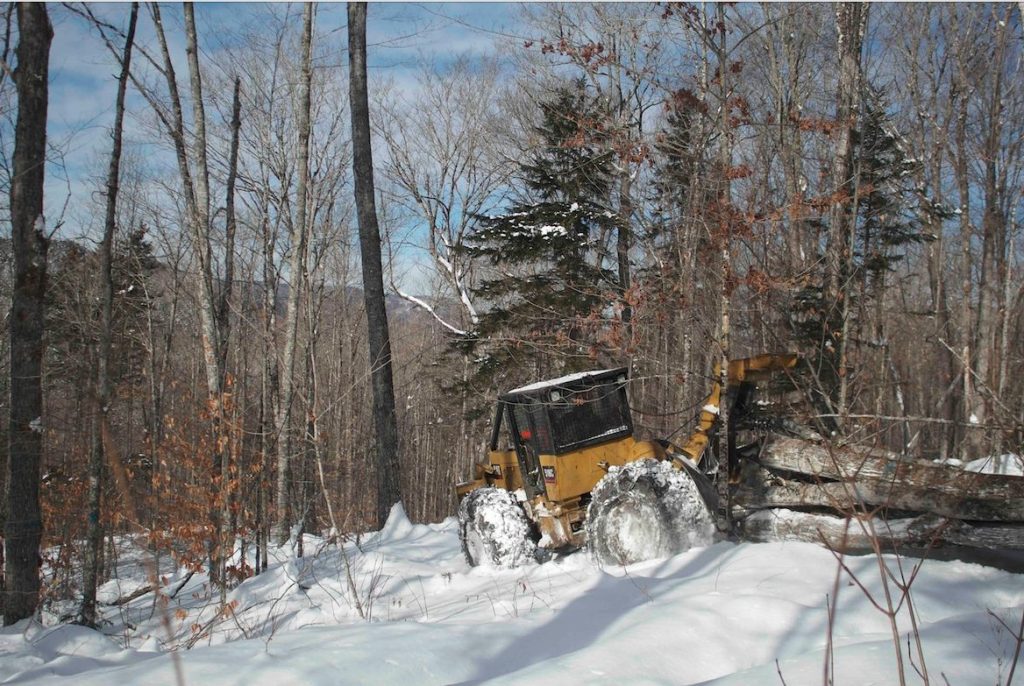 Logger Bryan Lambert pulling a hitch with his 1993 Cat 518C cable skidder on the Second College Grant.
