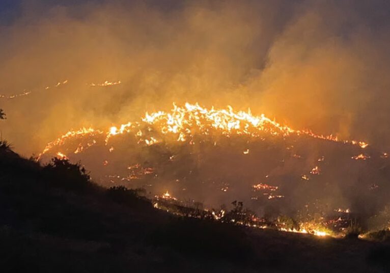 Firefighter posted as a lookout on the sunset fire.